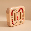 Wooden puzzle game with rotating pieces