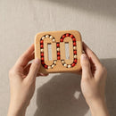Wooden puzzle game with rotating pieces